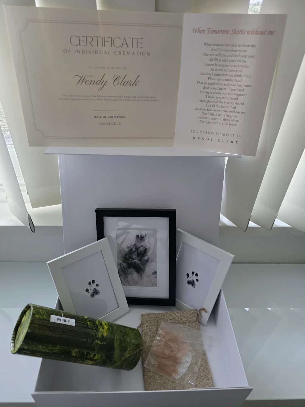 Wendy's cremation certificate, paw prints and memorial keepsakes
